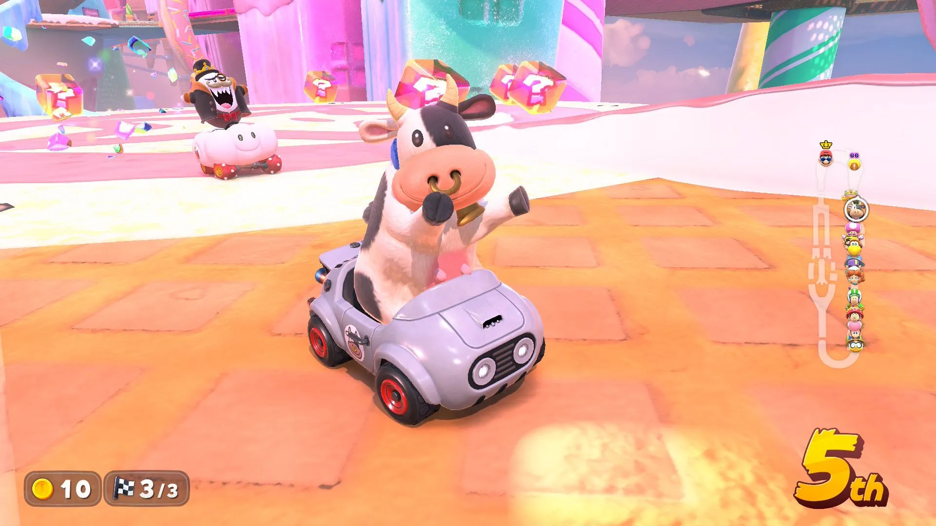 Một con bò NPC dễ thương bên đường đua trong game Mario Kart World