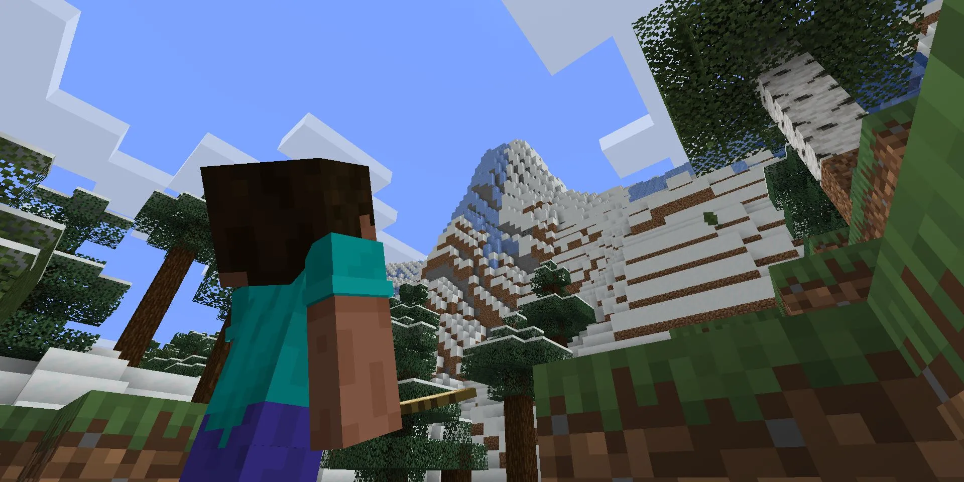 Hình ảnh Minecraft với Steve nhìn lên một vách đá lớn, tượng trưng cho sự khám phá và phiêu lưu trong thế giới khối