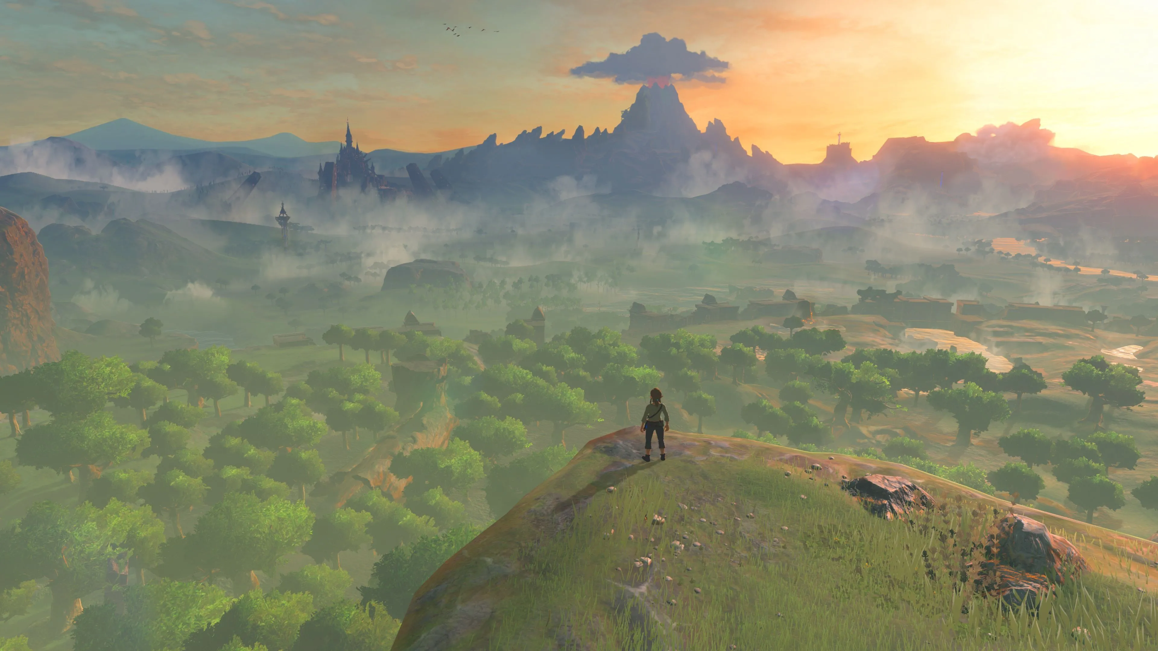 The Legend of Zelda Breath of the Wild, Link đứng trên đỉnh núi, ngắm nhìn khung cảnh Hyrule rộng lớn, thể hiện tự do khám phá.
